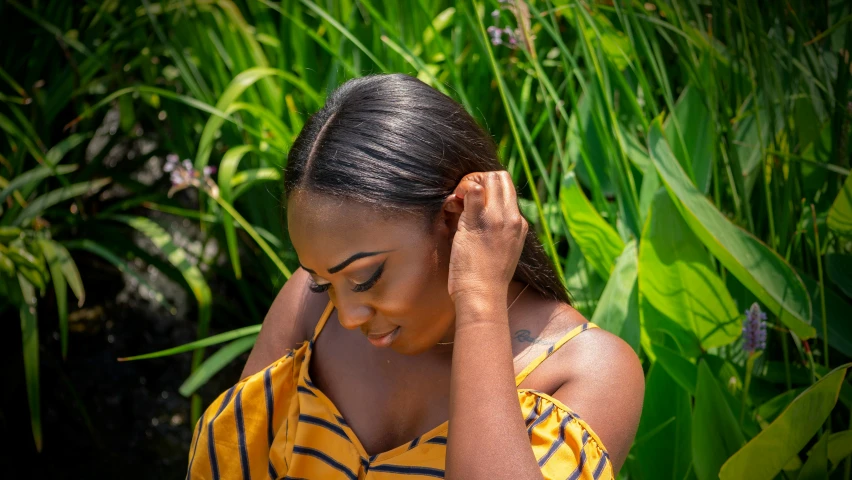 a woman that is in a field with green plants