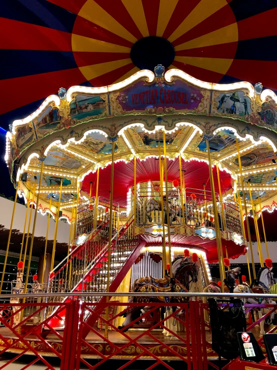 a carousel at night with many people