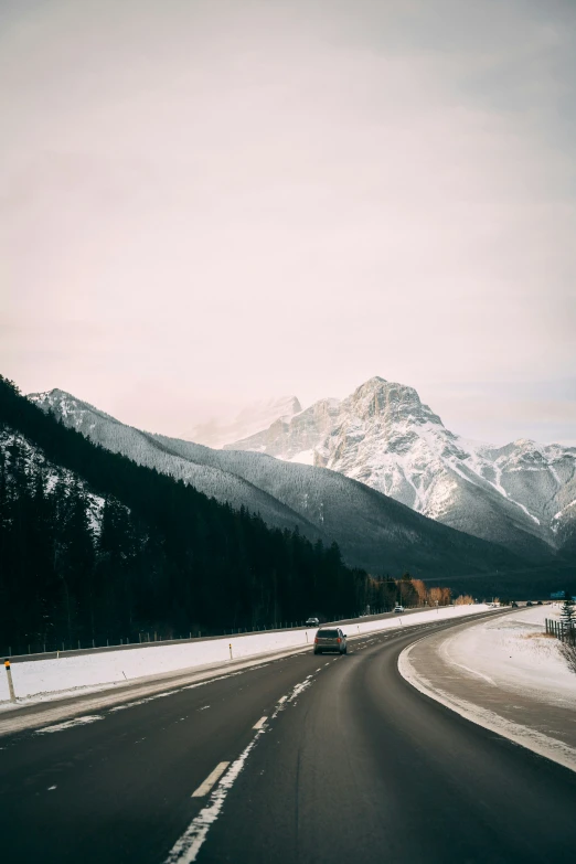 view of road with snow covered mountains in distance