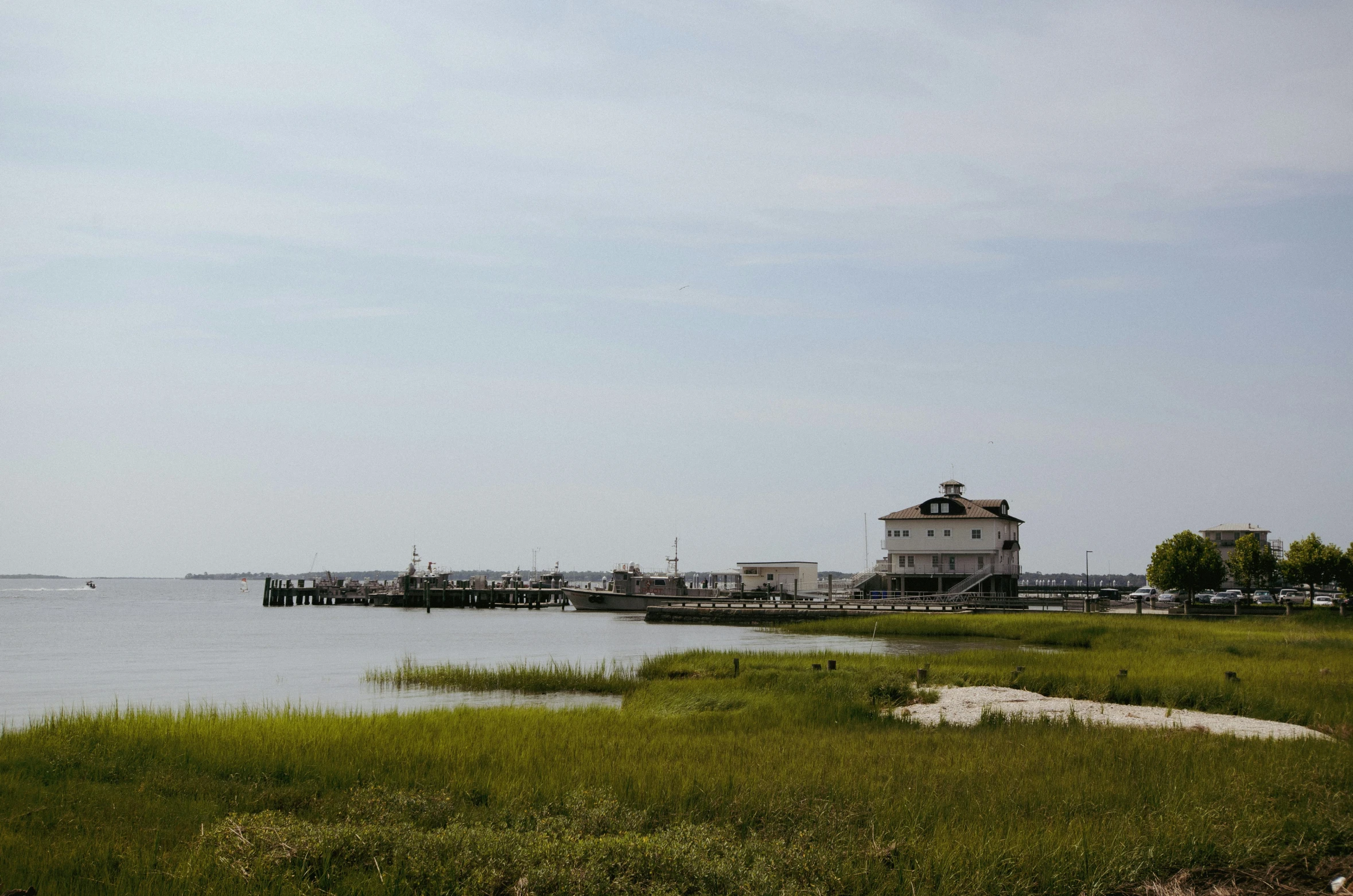 view of small lighthouse and pier from grass area