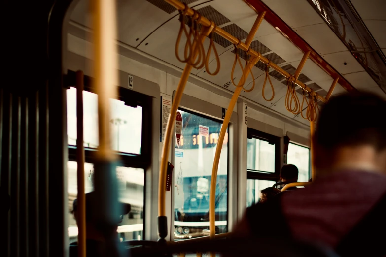 a man riding on a bus in the city
