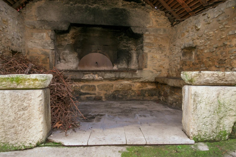 a door way with cement columns and green vegetation growing in it