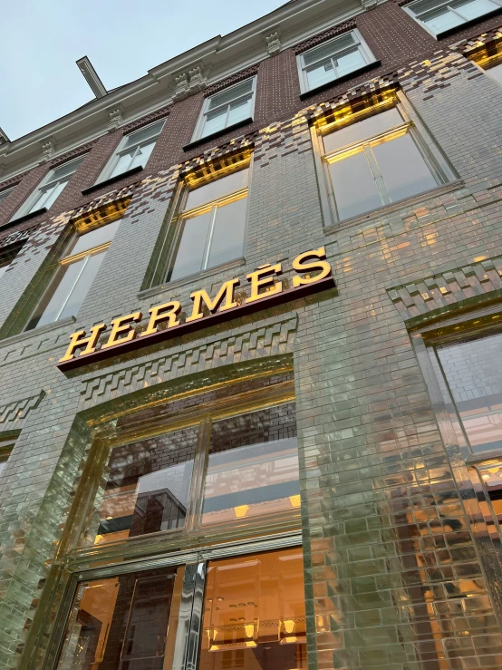 a storefront sign hanging from the side of a building