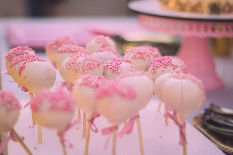 several cake pop candies are arranged on a plate