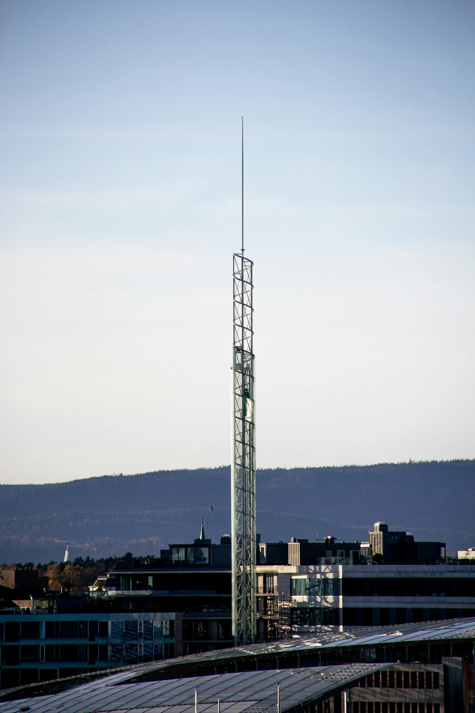 an aerial view of some buildings and a very tall tower