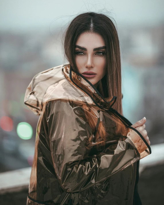 a beautiful young woman standing outside with her coat blowing in the wind