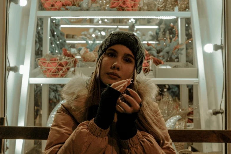 a woman eating food next to a display of glass