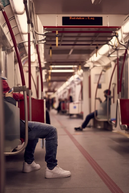 a person sitting on a bus with their feet crossed