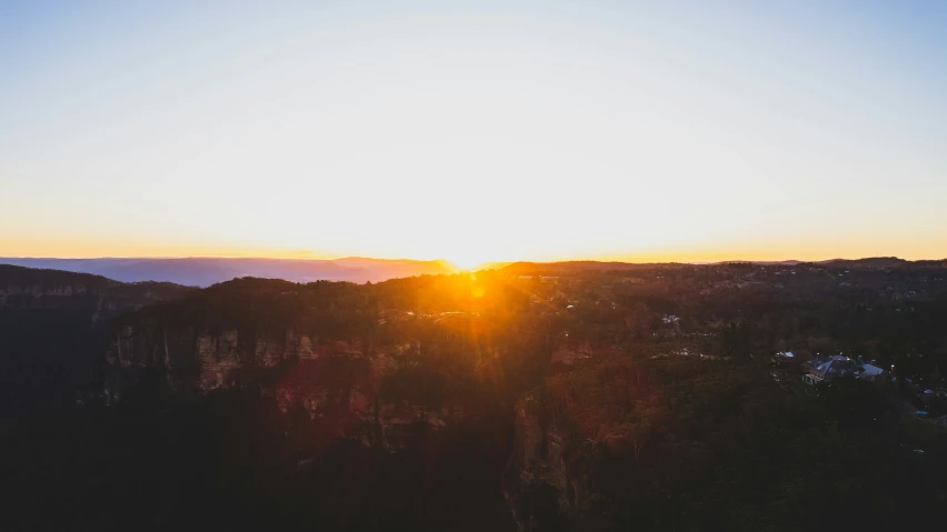 a view of a sunrise behind the mountains