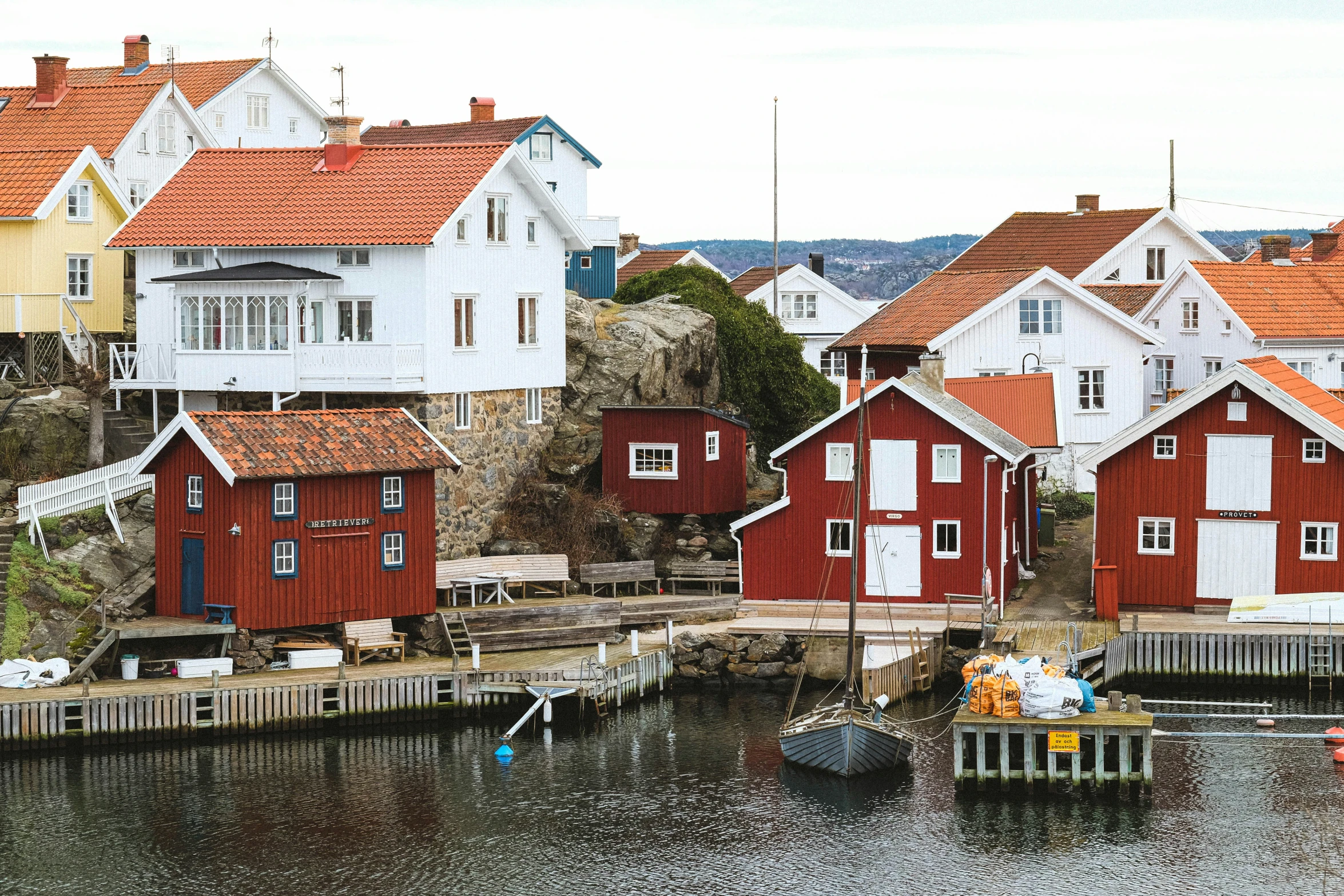 a couple of red houses sitting on top of a river