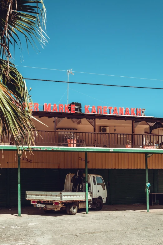 a small white truck sitting in front of a store