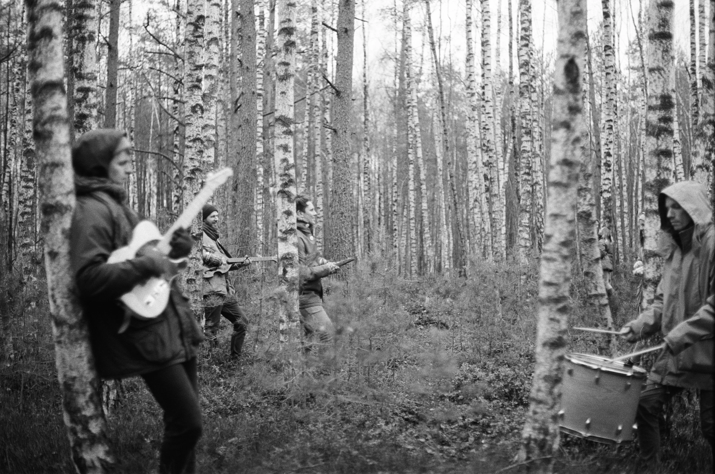 a band plays in a black and white forest