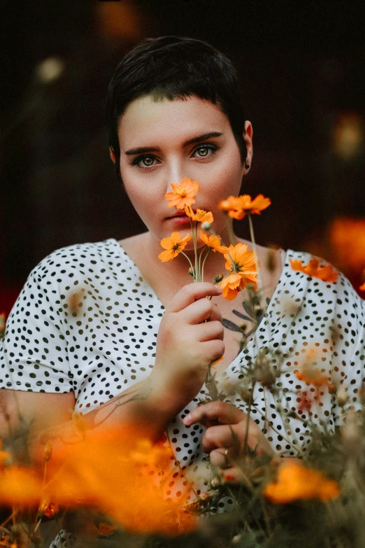 the woman is standing outside holding onto some flowers