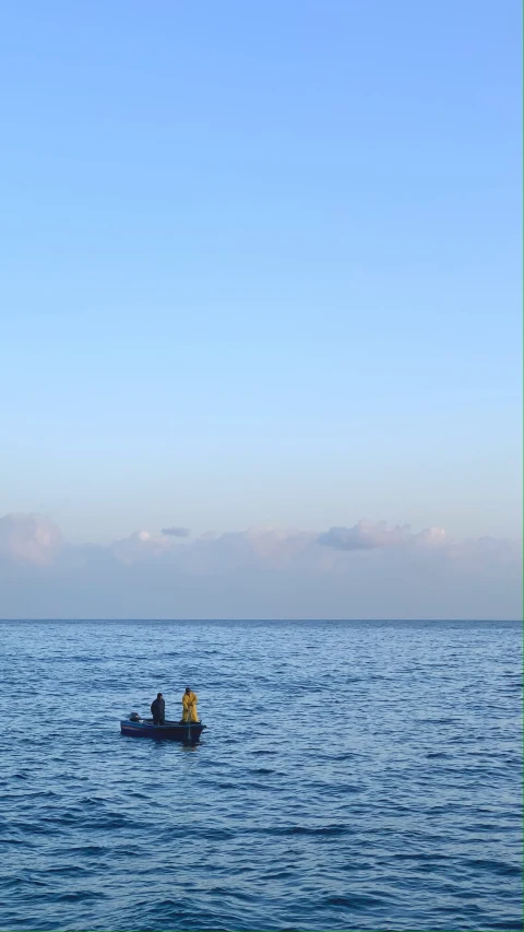 two people in a boat out in the open ocean