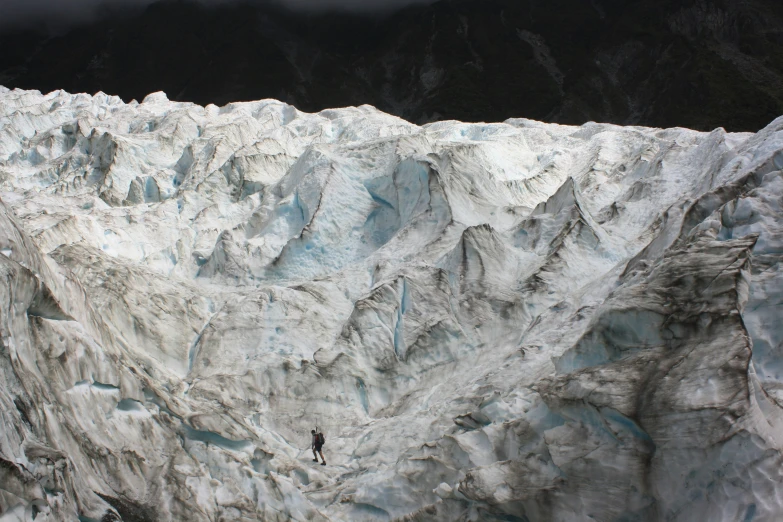 a man stands on the edge of an ice wall