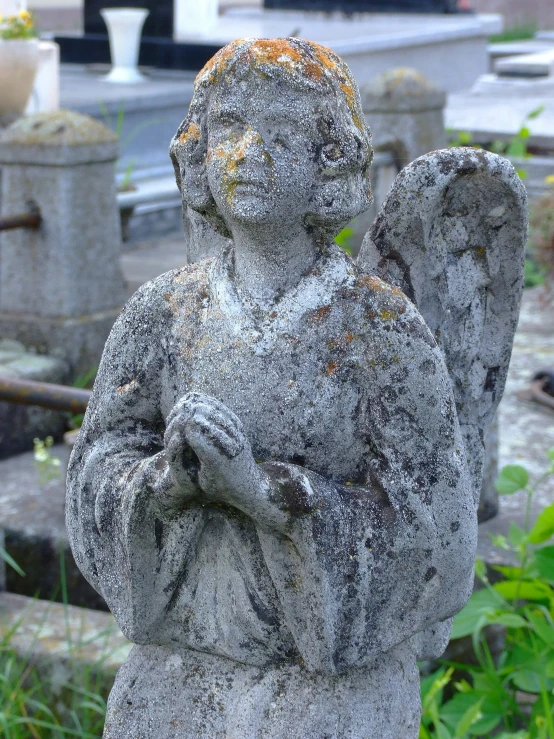 an old statue is shown in a cemetery