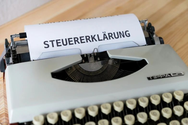 a typewriter with a paper that reads steuerlbergahling