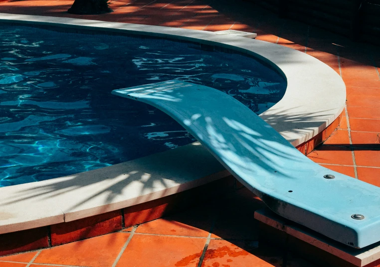 a pool with an artificial swimming slide on it