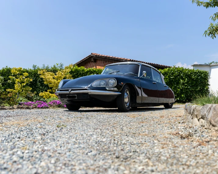 an old fashioned car sits parked outside a house