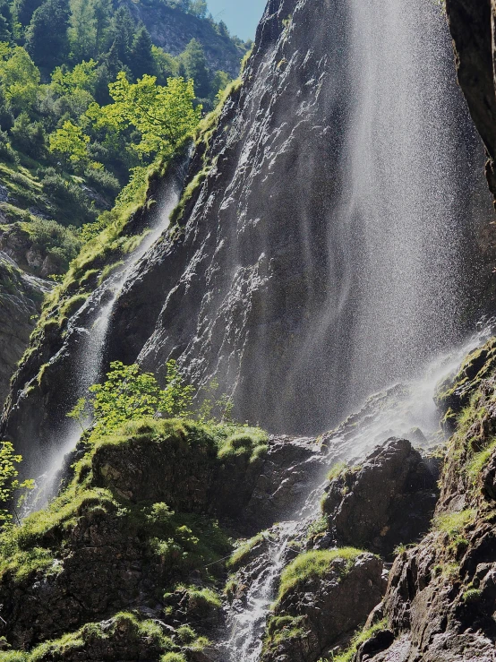 a man standing on top of a large waterfall