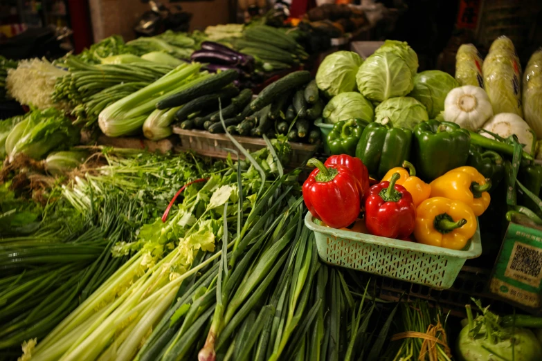 a large assortment of vegetables with multiple varieties in bins