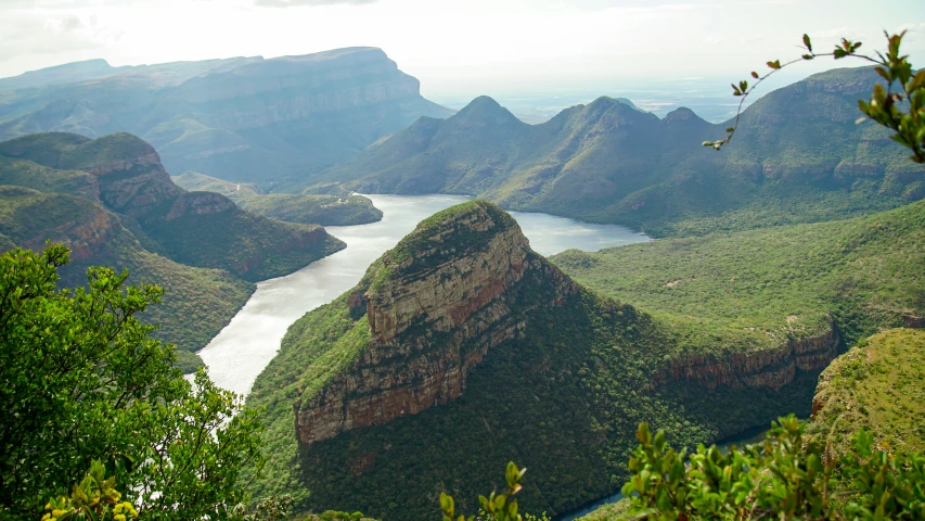 the mountain tops near the river make for a scenic location