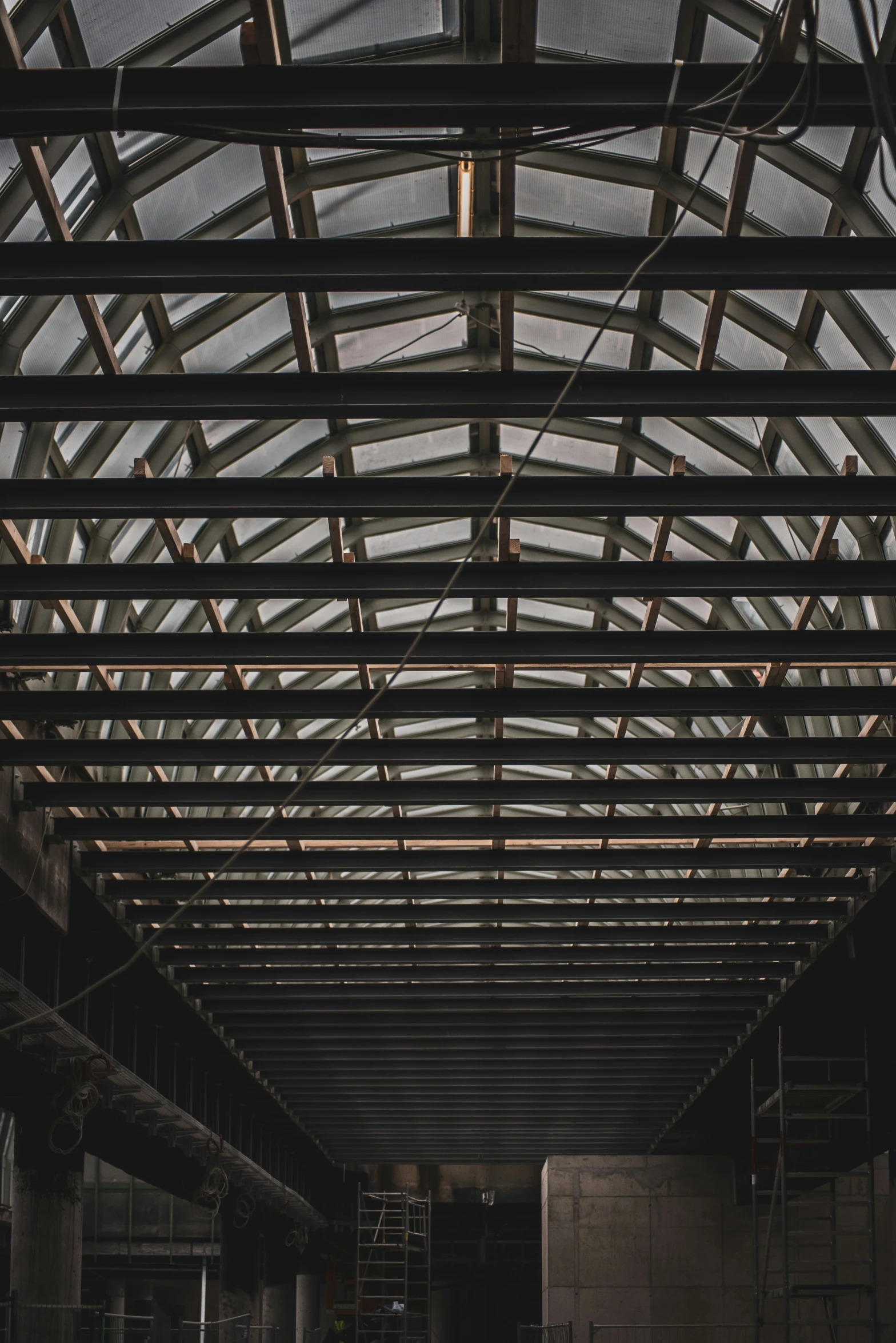 an empty building with metal beams and scaffolding