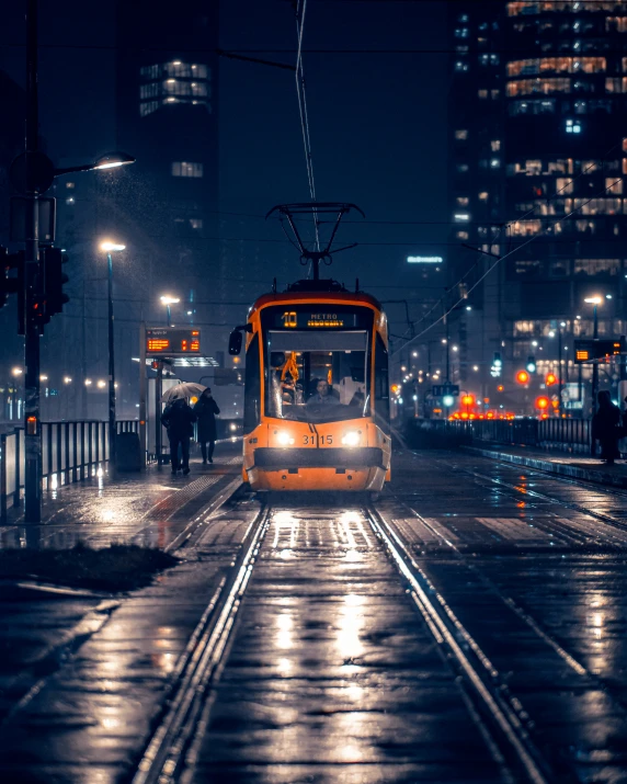 an electric trolley at night on the tracks