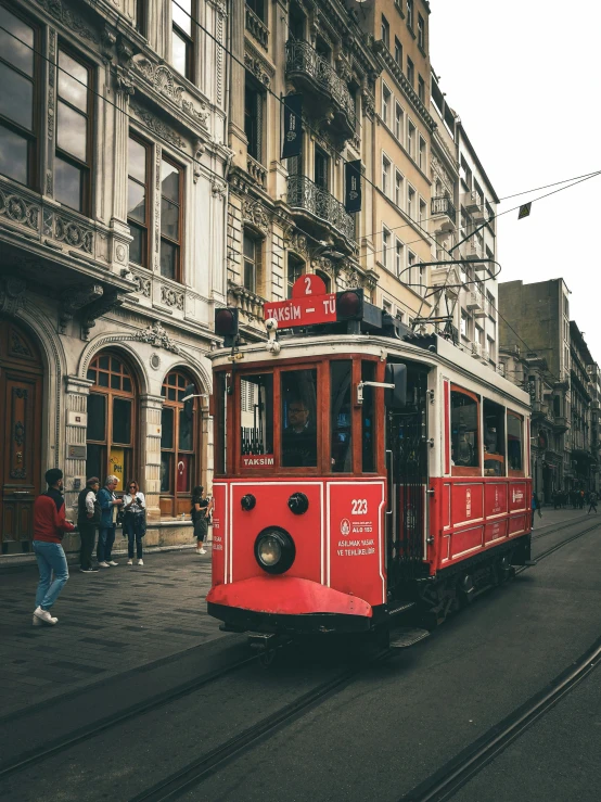 a red trolley is in the middle of an empty street