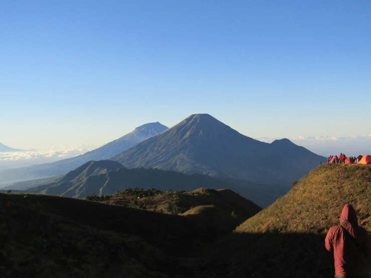 several people are standing at the top of a hill