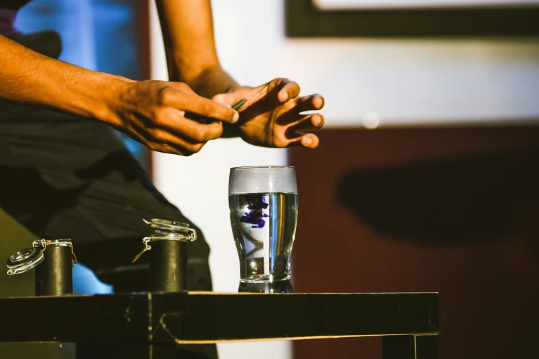 a man sits on a chair in front of a glass