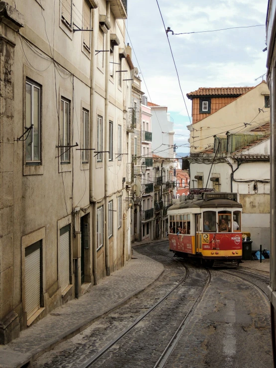 a street car on a city road next to old buildings