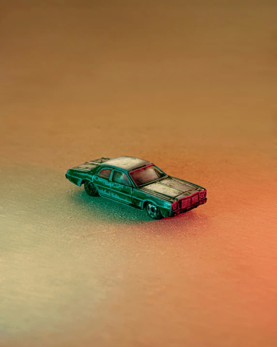 an orange and green toy car on a brown table