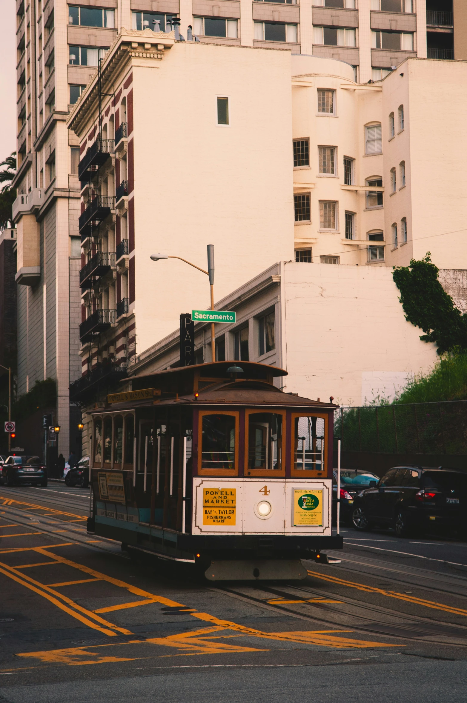 a trolley car with graffiti painted on the side driving down the street