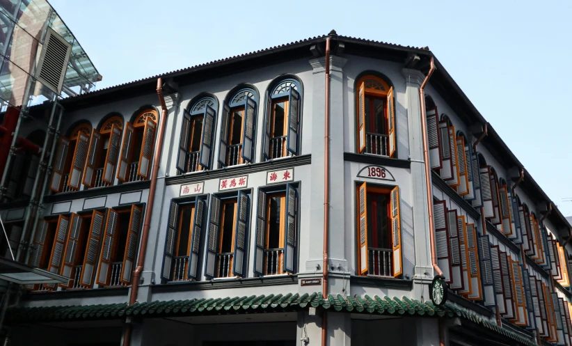 the building is gray and brown with windows