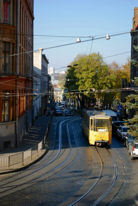 a bus drives down a busy road lined with cars