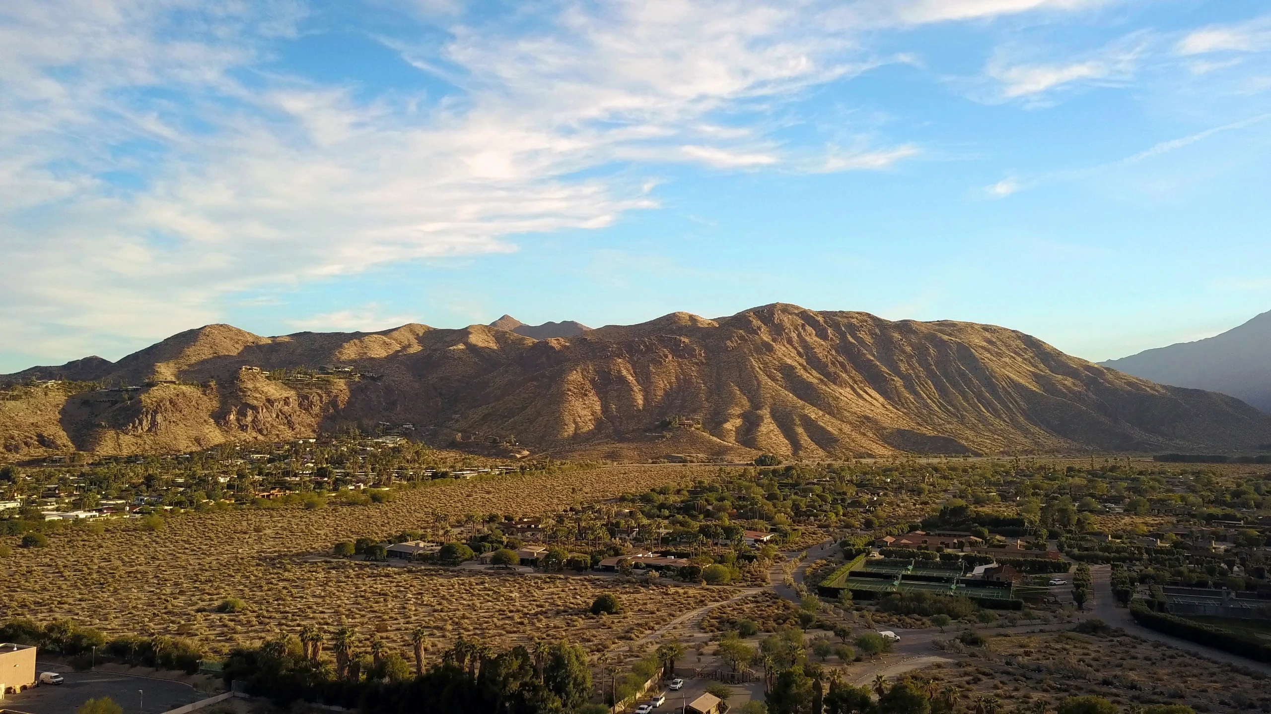 a large mountain range surrounded by a village