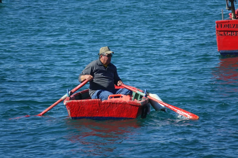 a person sitting in a small boat in the water