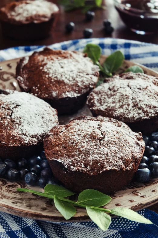 several muffins, blueberries and flowers on a table