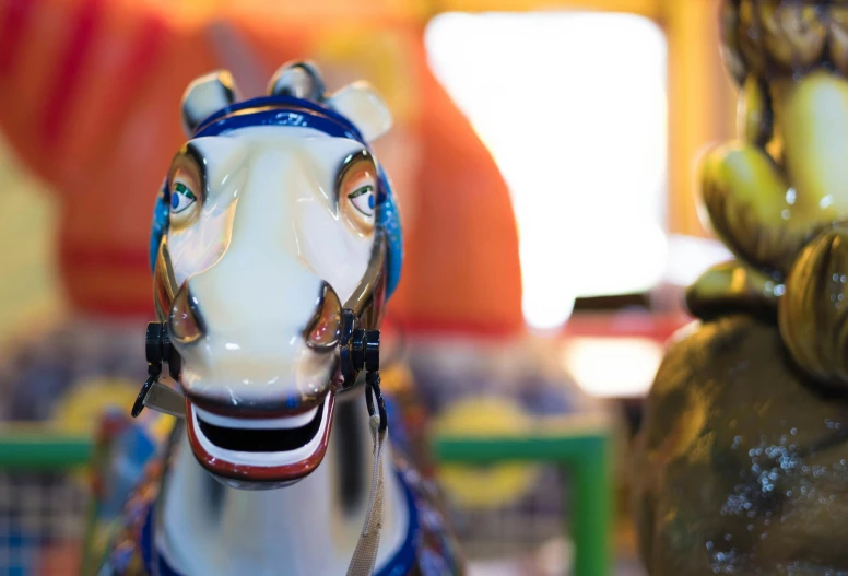 the toy horse is wearing a blue hat