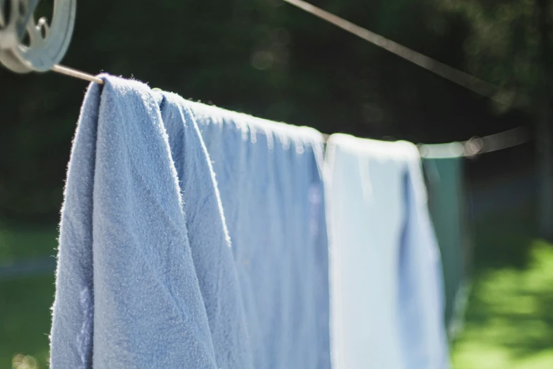 a blue towel and other towels hanging out