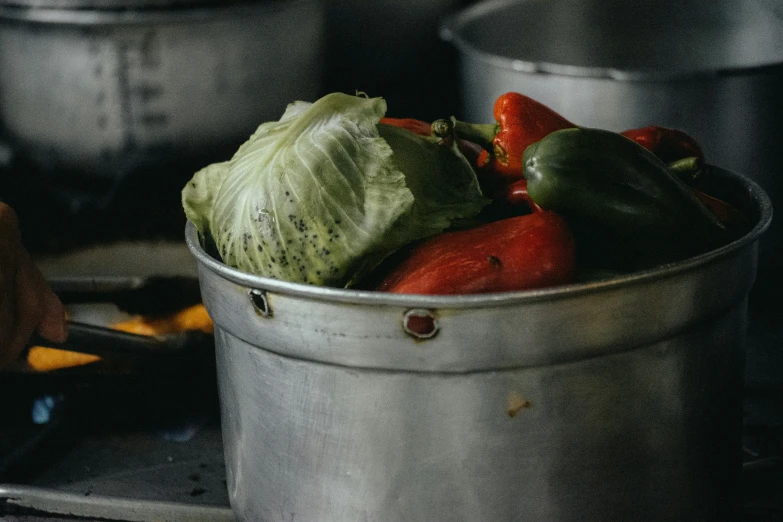 some food is in a white bucket on top of a stove