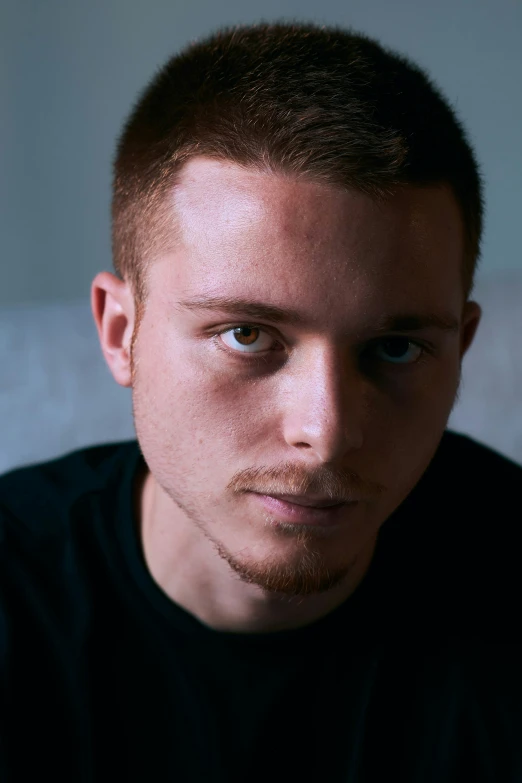 a man with blue eyes looks into the camera