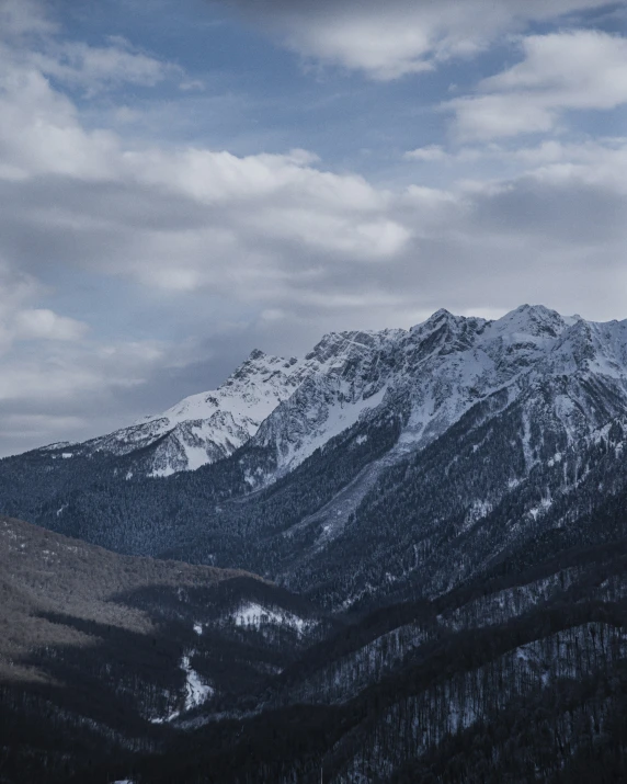 the landscape shows snowy mountains and the ocean