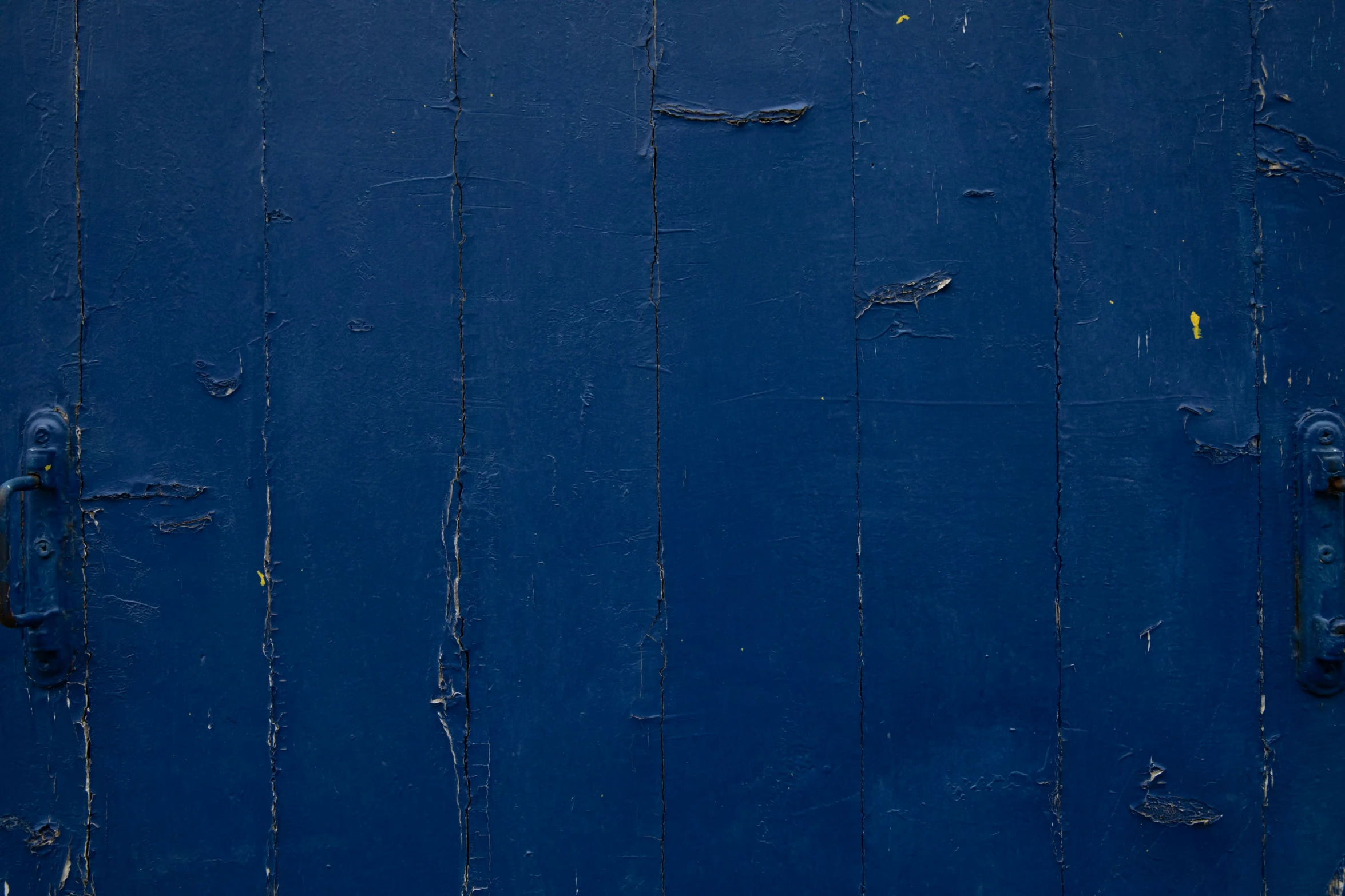 the wall is painted blue and is made of boards