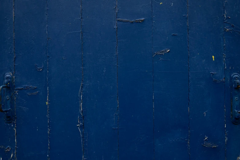 the wall is painted blue and is made of boards