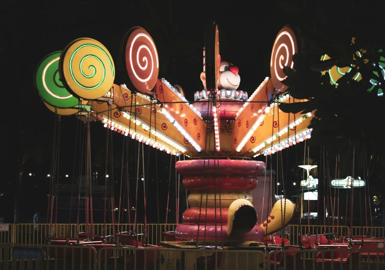 a carnival rides at night with large swings