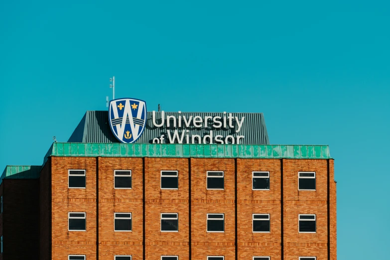 the university of the desert sign atop a brick building