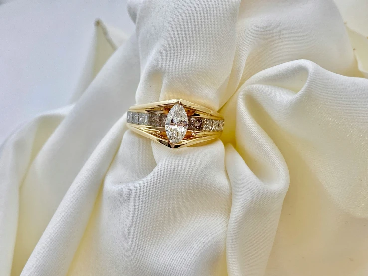 a ring with an arrow sits on top of a white cloth