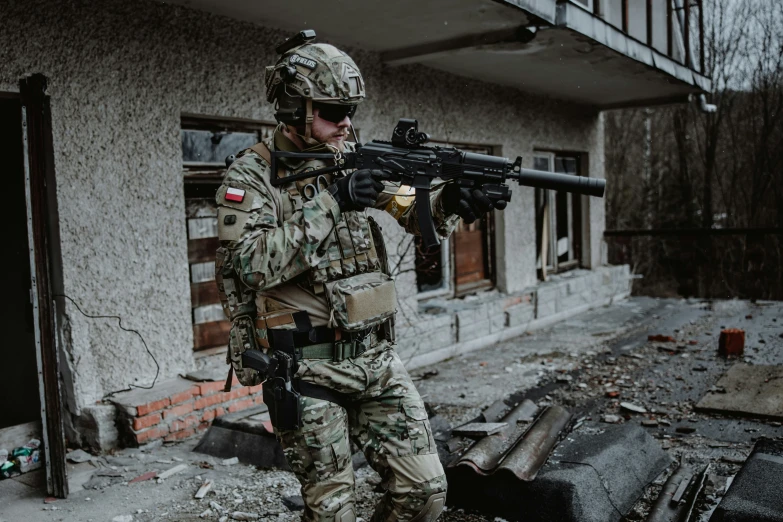 a soldier with an automatic rifle in the street